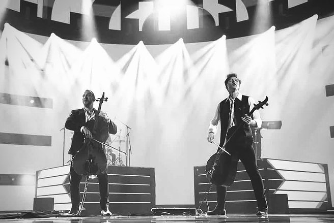 dariel and his brother performing on stage with their cellos