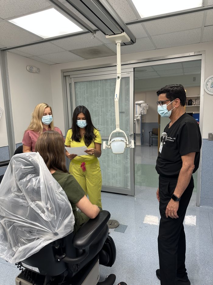 Thakkar and Doganci working with a patient