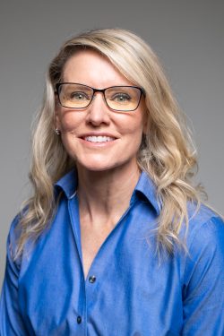 A blonde woman in glasses
