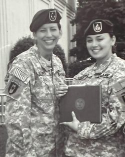 Two women in Army fatigues.